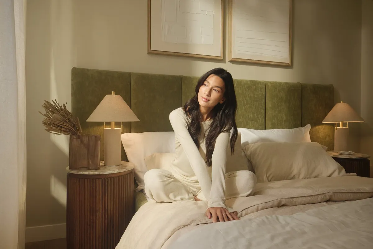 Woman in cozy bedroom interior